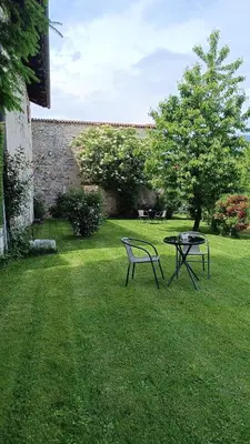 a table and a bench in a yard at Agritur Ciastel in Sanzeno