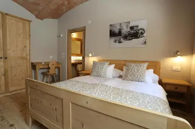 a bedroom with a large bed in a room at Agritur Ciastel in Sanzeno
