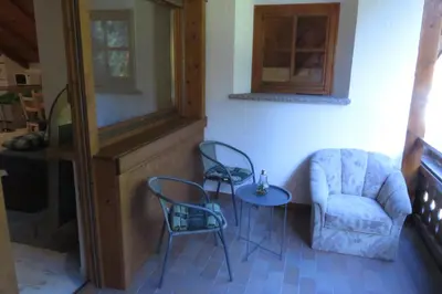a living room with a chair and a table at Pelegrin 15 in San Vigilio Di Marebbe