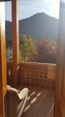 a balcony with a chair and a view of a mountain at Pelegrin 15 in San Vigilio Di Marebbe