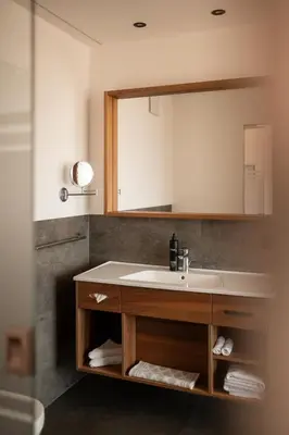 a bathroom with a sink and a mirror at Hotel Salgart in Merano