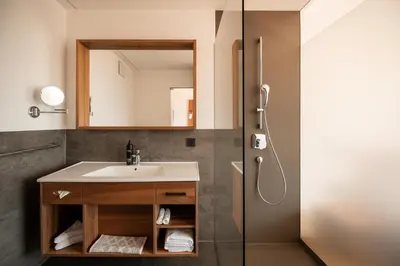 a bathroom with a sink and a shower at Hotel Salgart in Merano