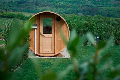 a small wooden door in a field of grass at Apartments Windegg in Caldaro