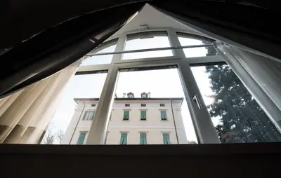 a view of a building through a window at Apartments Windegg in Caldaro