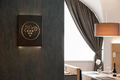 a room with a black wall with a picture on it at Apartments Windegg in Caldaro