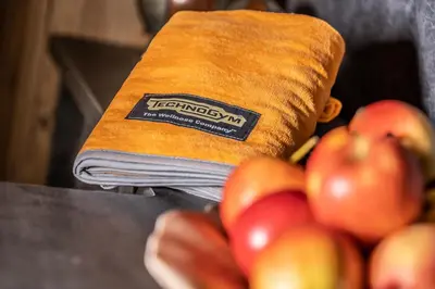 a napkin next to a pile of apples on a table at The Laurin Small & Charming in Selva di Val Gardena
