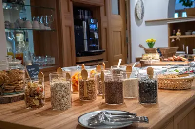a counter with several jars of food on a table at Hotel B&B Brunello in Ortisei