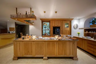 a large kitchen with a large island in the middle at Hotel B&B Brunello in Ortisei