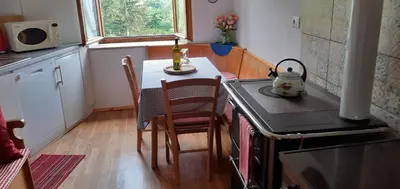 a small kitchen with a table and a stove at CASA IDA - ClPAT 22253 in Tregiovo