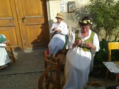 two older women in costumes standing outside a building at CASA IDA - ClPAT 22253 in Tregiovo