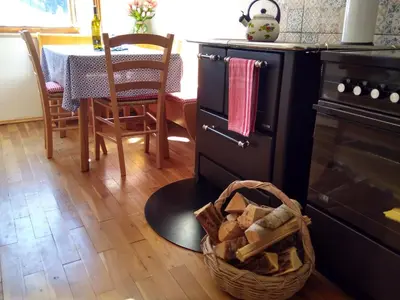 a kitchen with a table and a basket on the floor at CASA IDA - ClPAT 22253 in Tregiovo