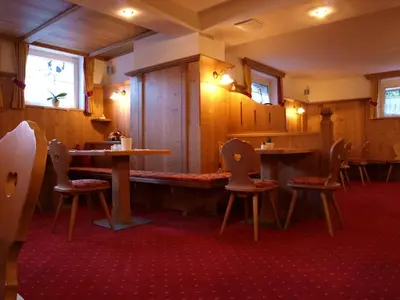 a restaurant with tables and chairs in a room at Garni Flurida in Selva di Val Gardena