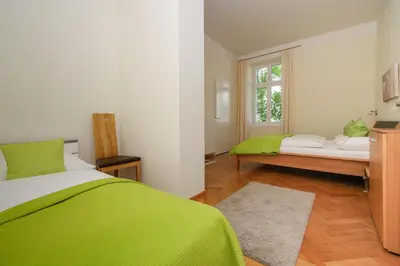 a bedroom with two beds and a window at Residence Diana in Merano