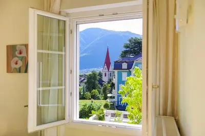 a window with a view of a city at Residence Diana in Merano