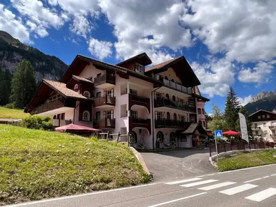 a large building on the side of a road at Albergo Conturina in Canazei