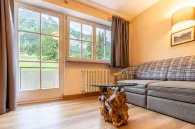 a living room with a couch and a table at Albergo Conturina in Canazei