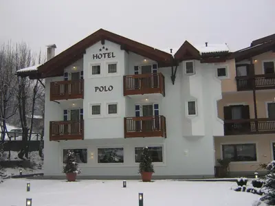 a hotel building with snow in front of it at Hotel Al Polo in Ziano di Fiemme