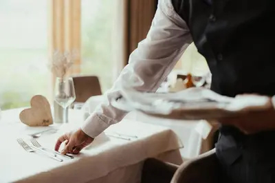 a man sitting at a table in a restaurant at Hotel Lech Da Sompunt in Badia