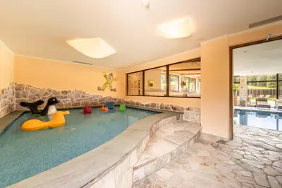 a pool in a home with a indoor swimming pool at Monte Pana Dolomites Hotel in Santa Cristina in Val Gardena