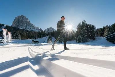 a man is cross country skiing in the snow at Monte Pana Dolomites Hotel in Santa Cristina in Val Gardena