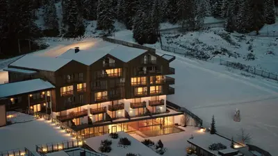 an aerial view of a large building in the snow at Hotel Cristal in Obereggen