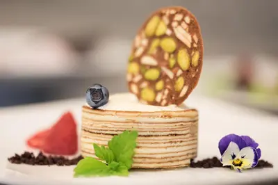 a cake with an egg on top of it on a plate at Hotel Cristal in Obereggen