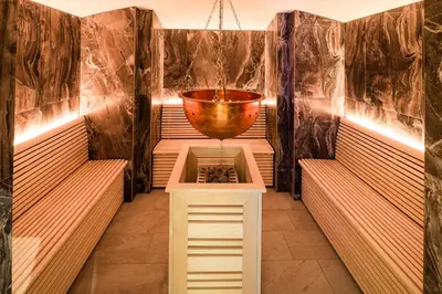a sauna with a large bowl on a stand at Hotel Cristal in Obereggen