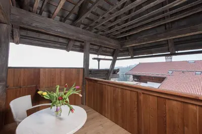 a vase of flowers on a table on a balcony at Hotel Ansitz Kematen ***S in Collalbo