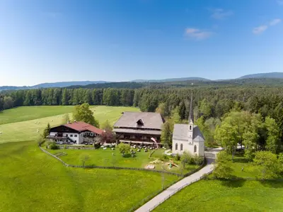 an aerial view of a church in a green field at Hotel Ansitz Kematen ***S in Collalbo