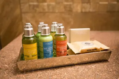 a tray with four bottles of liquids on a counter at Chalet Marcora in Campitello di Fassa