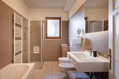 a bathroom with a sink and a toilet and a shower at Mederle Hof in Appiano sulla Strada del Vino