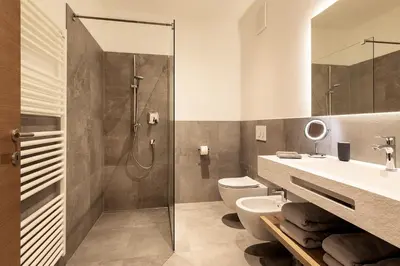 a bathroom with a shower and a sink and a toilet at Mederle Hof in Appiano sulla Strada del Vino