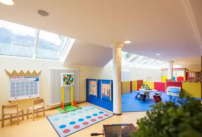 a room with a play room with a table and chairs at Hotel Prokulus - Family & Wellness in Naturno