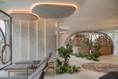 a lobby with benches and plants in a building at Hotel Prokulus - Family & Wellness in Naturno