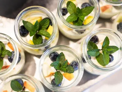 a group of small jars filled with fruit and mint at Hotel Weingut Innerleiterhof in Schenna