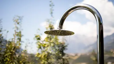 a shower head with water coming out of it at Hotel Weingut Innerleiterhof in Schenna