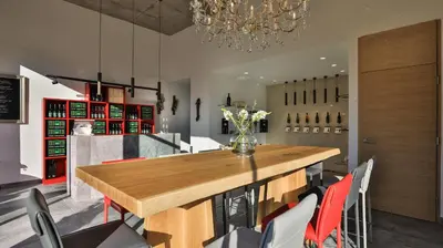 a dining room with a large wooden table and chairs at Hotel Weingut Innerleiterhof in Schenna
