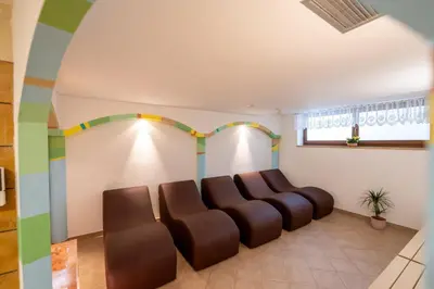 a waiting room with a bunch of chairs in it at Hotel Dolomites Inn in Canazei