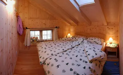 a room with a staircase with a wooden door and a stair case at Camping Catinaccio Rosengarten in Pozza di Fassa