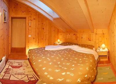 a kitchen with wooden cabinets and a sink at Camping Catinaccio Rosengarten in Pozza di Fassa