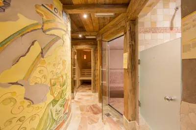 a hallway with a painting on the wall at Camping Catinaccio Rosengarten in Pozza di Fassa