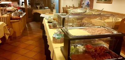 a buffet line in a restaurant with food on it at Hotel Ciampian in Moena