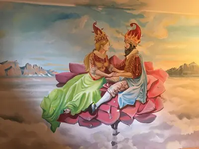 a painting of a couple sitting on a flower at Hotel Laurino in Pozza di Fassa