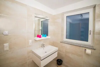 a bathroom with a sink and a mirror at Residence Fiegl in Schenna