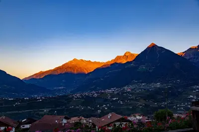 a view of a mountain range with a town and a city at Pension Obertaberhof in Schenna