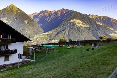 a view of a mountain range with a resort at Pension Obertaberhof in Schenna