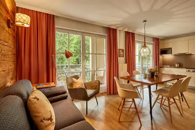 a living room with a couch and a table at Appartamenti La Sajun & Les Viles in La Villa