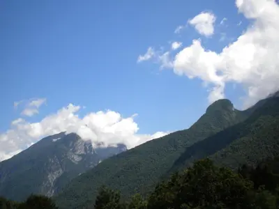 a view of a mountain range with clouds in the sky at B&B DOLOMIA in Sagron Mis