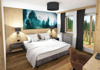 a bedroom with a bed and a painting on the wall at Hotel Cirelle Suite & Spa in Canazei