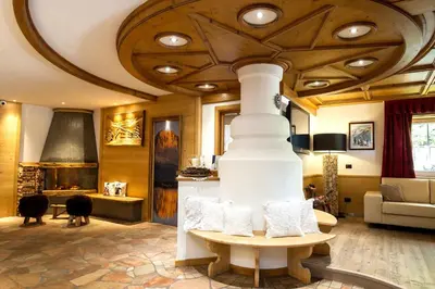 a living room with a couch and a table at Residence Cirelle Suite & Spa in Canazei